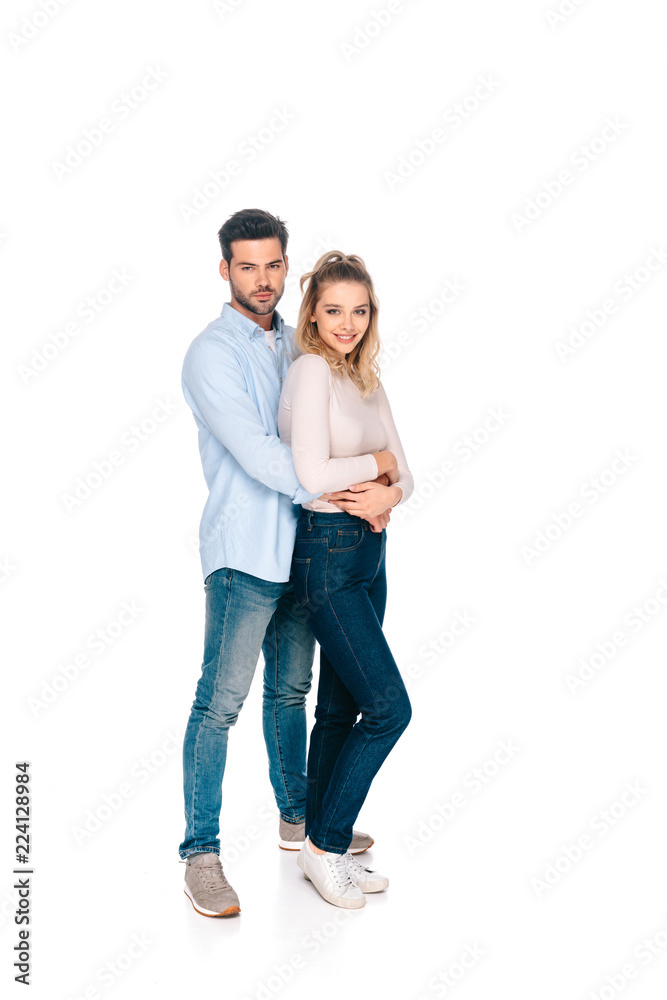 full length view of beautiful happy young couple embracing and smiling at camera isolated on white full length view of beautiful happy young couple embracing and smiling at camera isolated on white