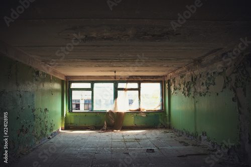 Empty room with broken windows in ruined abandoned building inside interior