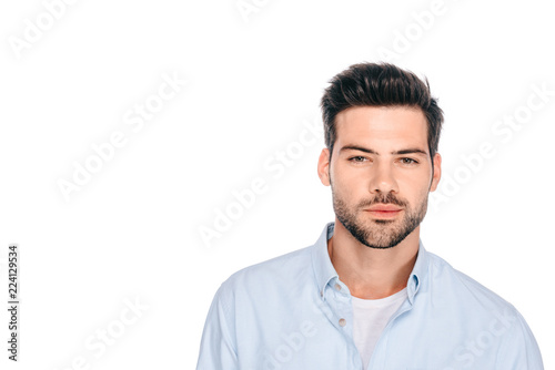 portrait of handsome young man looking at camera isolated on white