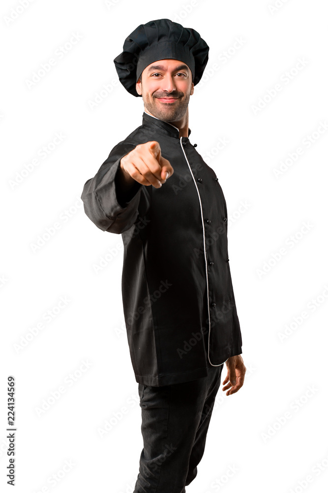 Chef man In black uniform points finger at you with a confident expression on isolated white background Chef man In black uniform points finger at you with a confident expression on isolated white background