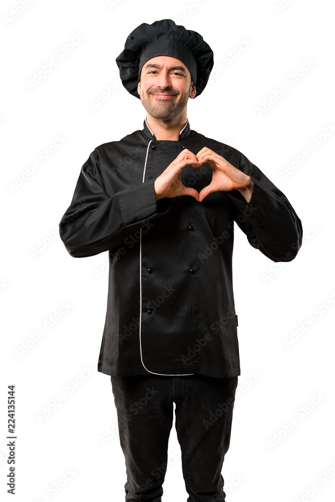 Chef man In black uniform making heart symbol by hands. Being in love on isolated white background Chef man In black uniform making heart symbol by hands. Being in love on isolated white background