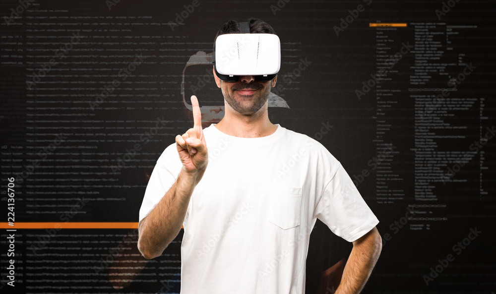 Naklejka premium Man using VR glasses counting one inside the virtual reality mode