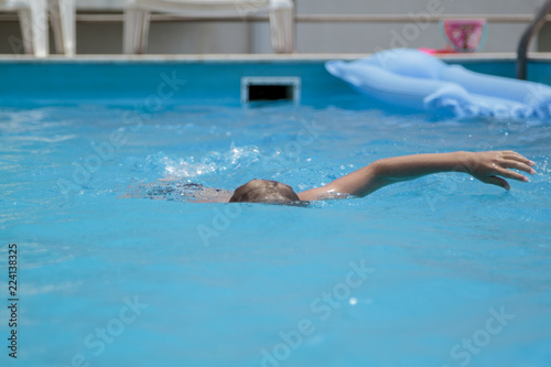boy swimming in the pool © sommersby