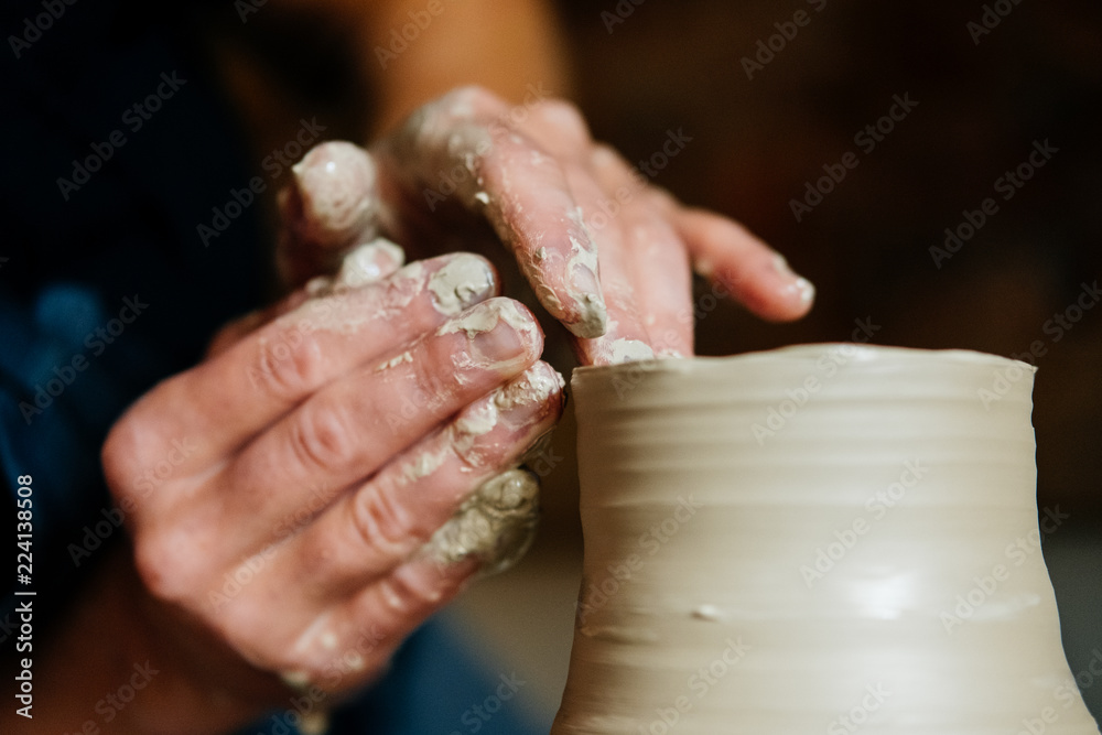 Creation of a vase and modeling of clay in a professional pottery workshop