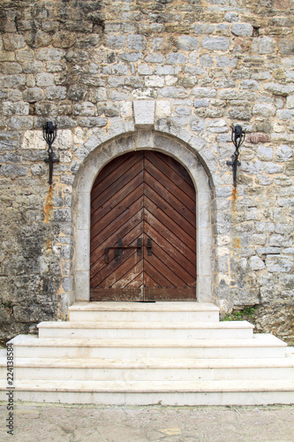 gate with steps of castle with stone wall in Budva Old Town, Montenegro