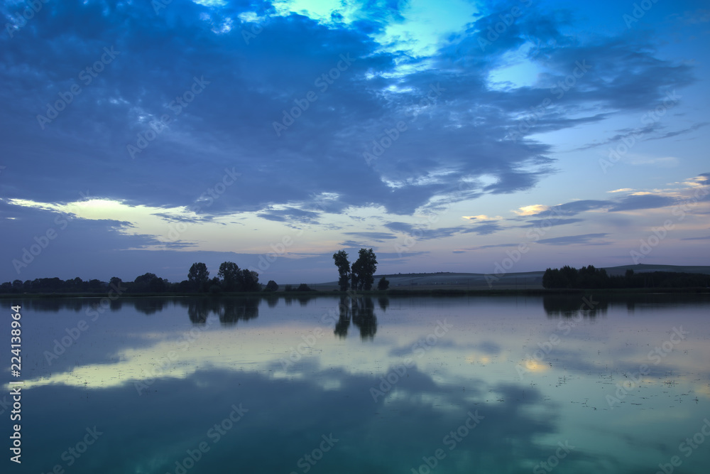 Reflection of evening clouds in the lake