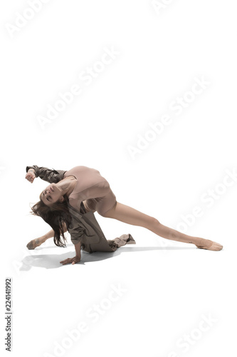 Beautiful slim young female modern jazz contemporary style ballet dancer in silhouette wearing beige long cloak isolated on a white studio background