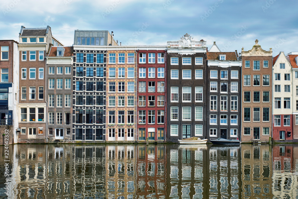 Amsterdam canal Damrak with houses, Netherlands