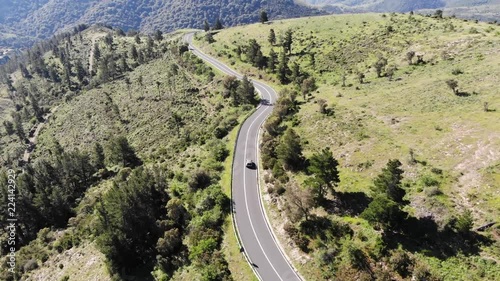 Car chase aerial view on beautiful mountain road photo