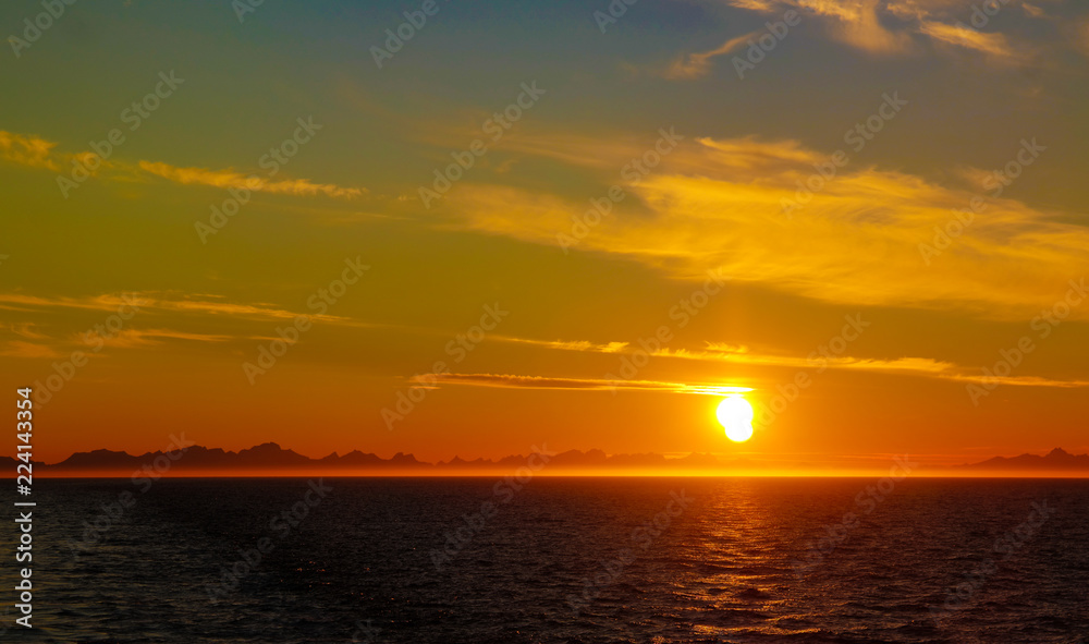 Sunset and sunrise over the sea and Lofoten archipelago from the Moskenes - Bodo ferry, Norway
