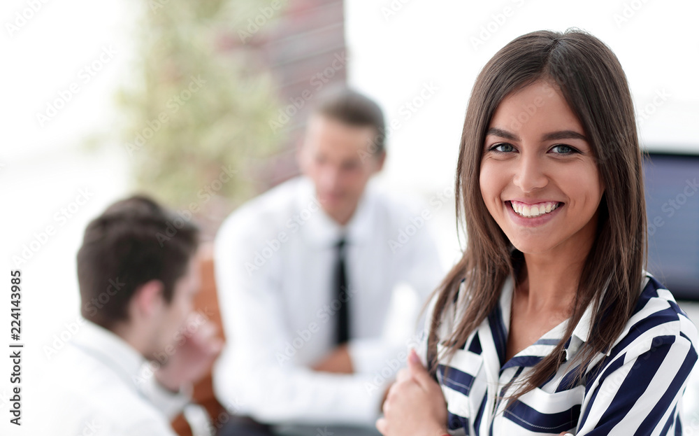 Young businesswoman sitting at desk in office Young businesswoman sitting at desk in office