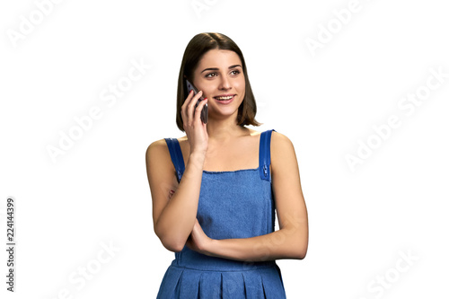 Charming brunette woman talking on phone. Happy young woman talking on cell phone isolated on white background with copy space.