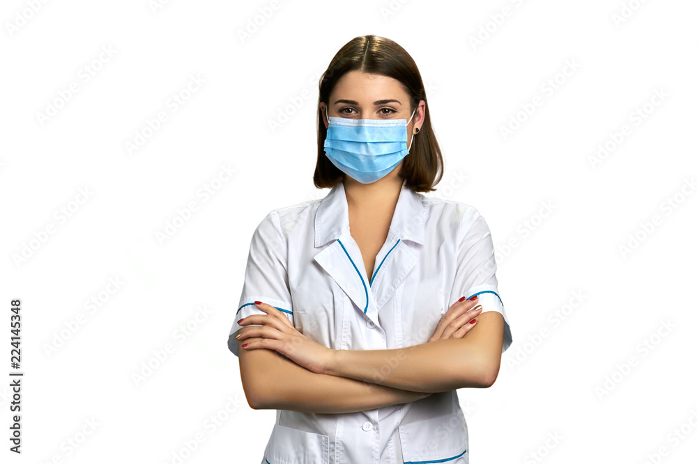 Woman doctor in face mask on white background. Beautiful female doctor with arms crossed, portrait. Woman doctor in face mask on white background. Beautiful female doctor with arms crossed, portrait.