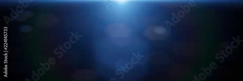 beautiful blue lens flare effect overlay texture with bokeh effect and anamorphic light streak in front of a black background banner