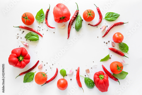 Colorful pizza ingredients pattern made of tomatoes, pepper, chili, garlic and basil on white background. Cooking concept. Top view. Flat lay. Copy space