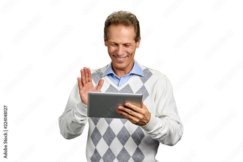 Handsome smiling man with pc tablet. Studio shot of nice middle-aged man looking friendly and making waving gesture over white background. Handsome smiling man with pc tablet. Studio shot of nice middle-aged man looking friendly and making waving gesture over white background.
