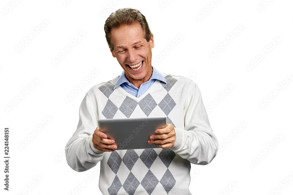 Portrait of laughing man holding digital tablet. Casual man is laughing while looking on computer tablet, isolated on white background. People, technology and fun. Portrait of laughing man holding digital tablet. Casual man is laughing while looking on computer tablet, isolated on white background. People, technology and fun.