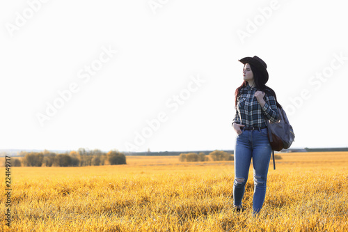 A young girl is traveling around the city hitchhiking. A beautif © alexkich