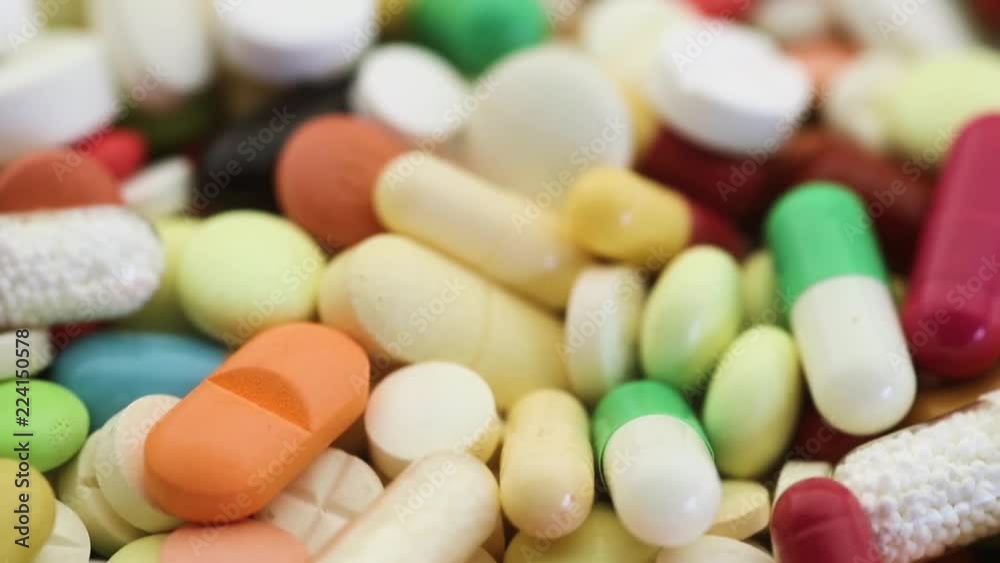 Closeup tilt shot focusing in on selection of pills Closeup tilt shot focusing in on selection of pills