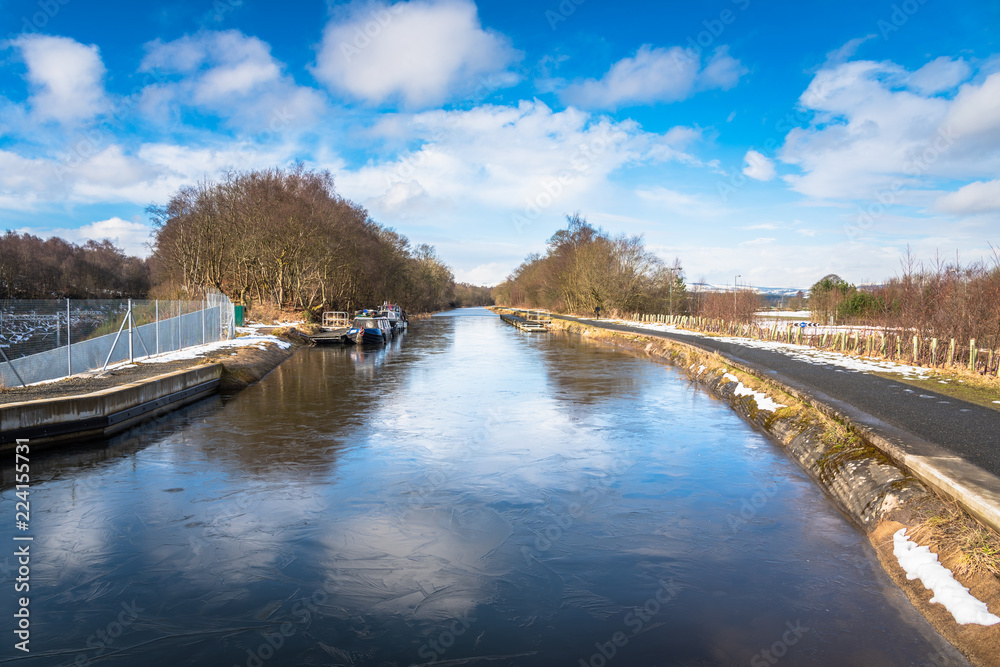 Frozen Canal in the Countryside of Scotland and Blue Sky. Frozen Canal in the Countryside of Scotland and Blue Sky.