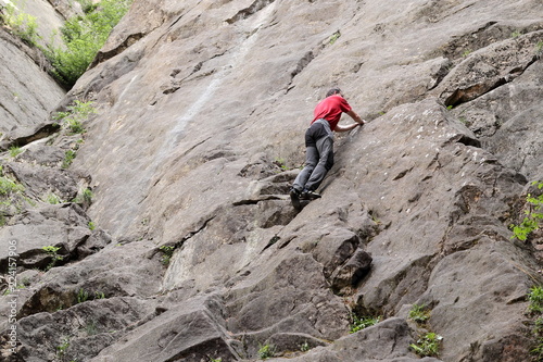 Mann klettert an Sandsteinfelsen photo