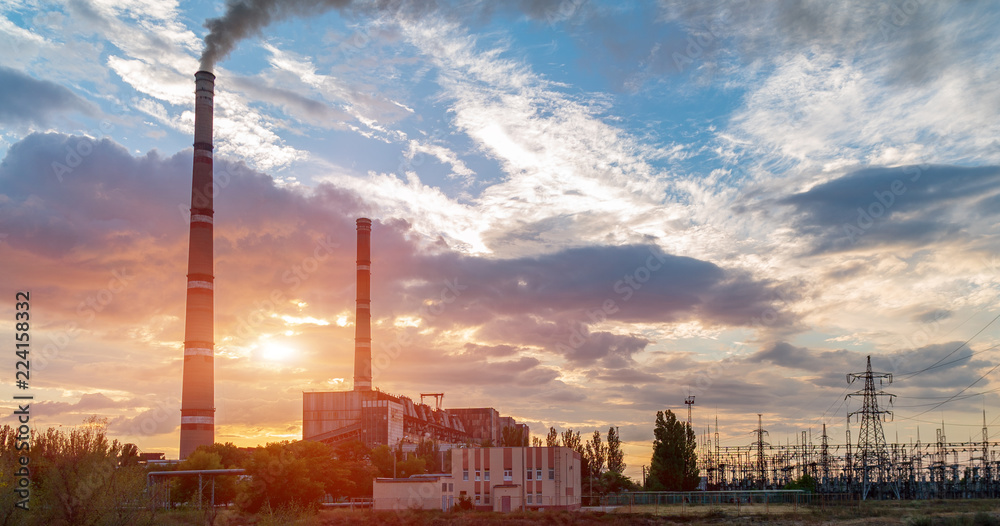 Naklejka premium distribution electric substation with power lines and transformers, at sunset