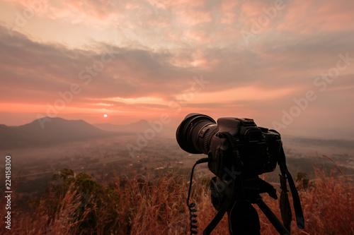 Landscape DSLR camera on tripod with a lot of fog Phu Thok Mountain at Chiang Khan ,Loei Province in Thailand.