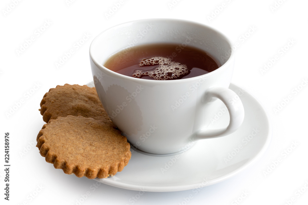 A cup of black tea with two gingerbread biscuits isolated on white. White ceramic cup and saucer. A cup of black tea with two gingerbread biscuits isolated on white. White ceramic cup and saucer.