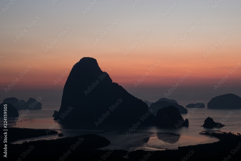 Island with great mountain silhouette with beautiful sunrise sky. From Samet Nangshe viewpoint, Phang Nga, Thailand.