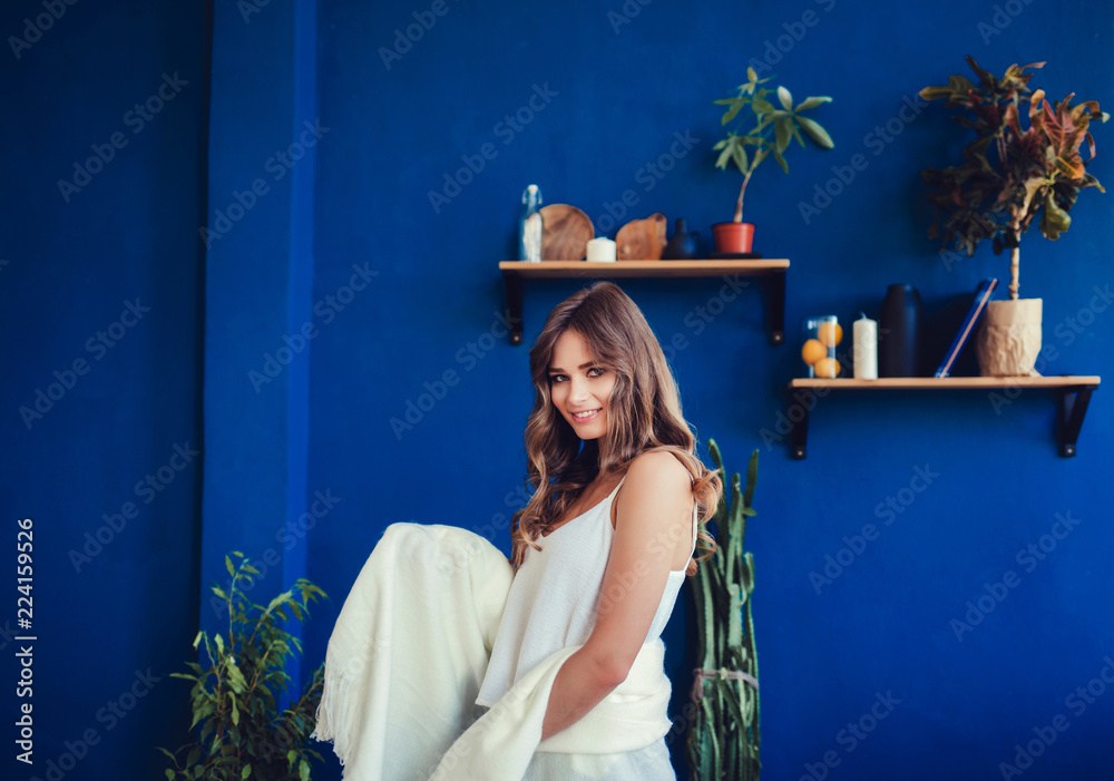 Trendy sexy young woman wearing casual clothes posing over blue background Trendy sexy young woman wearing casual clothes posing over blue background