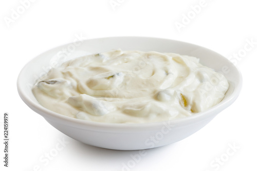 Tzatziki in white ceramic bowl isolated on white.