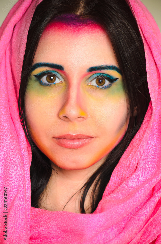 Young caucasian woman with colorful makeup and pink head shawl Young caucasian woman with colorful makeup and pink head shawl