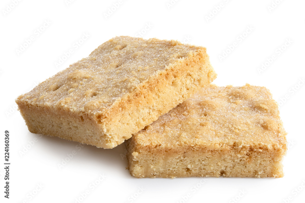 Two classic homemade square shortbread biscuits isolated on white.
