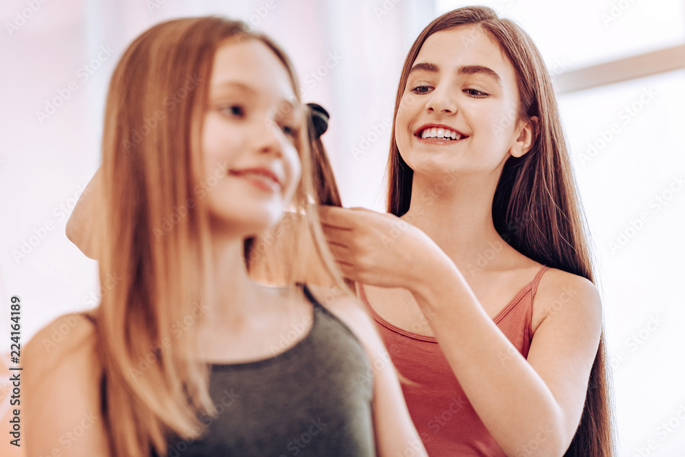 Home interaction. Amazing brunette being attentive while helping her friend to prepare for party Home interaction. Amazing brunette being attentive while helping her friend to prepare for party