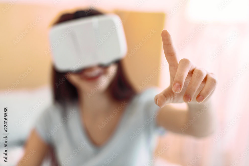 Like it. Silhouette of smiling girl that being at home and playing with modern gadget Like it. Silhouette of smiling girl that being at home and playing with modern gadget