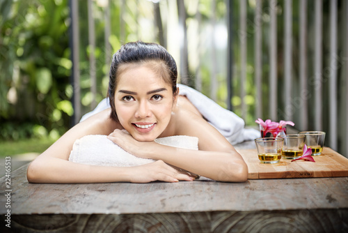 Smiling asian woman enjoying skin care