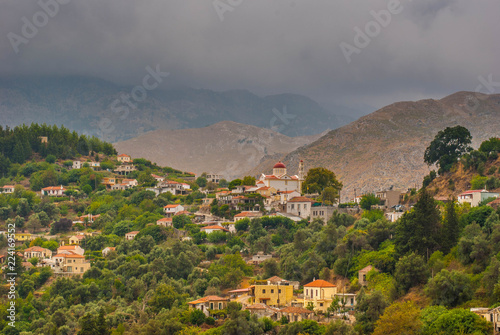 dramatic view landscape, mountain village on the slopes in Greece under the approaching thunderstorm