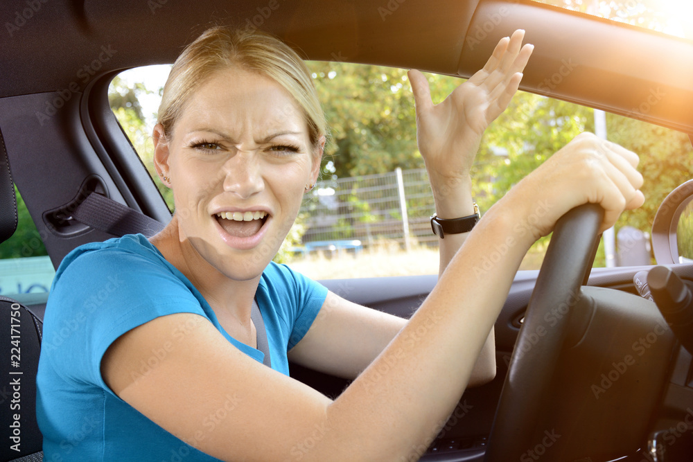 Φωτογραφία Woman as a car driver is in stress and scolds of annoyance during the car ride