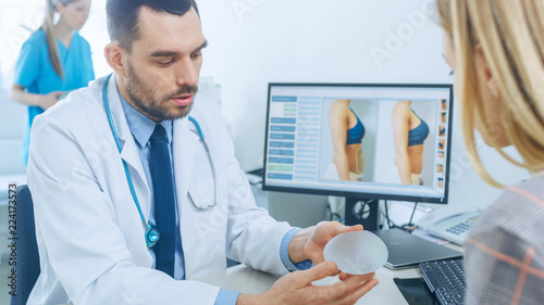 фотографія Plastic / Cosmetic Surgeon Shows Female Patient Breast Implant Samples for Her Future Surgery