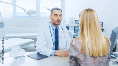 Plastic / Cosmetic Surgeons Shows Female Patient Possible Results of Liposuction, He Points on Computer Screen Showing Reduction of Fat Tissue on a Stomach.