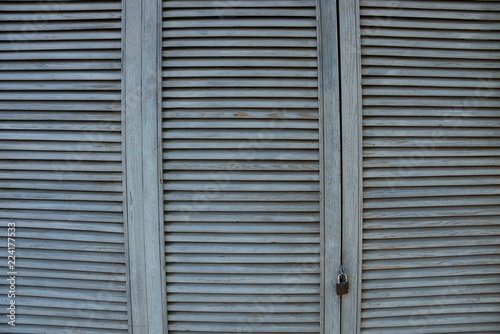 gray wooden background of thin boards in a lattice on the door © butus