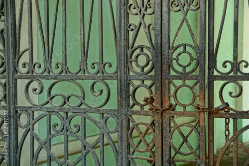metal texture of black and rusty steel bars with a forged pattern on the gate