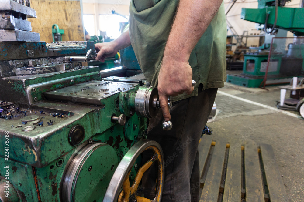 Worker, a man processes metal products on a machine. Turning work in production. Worker, a man processes metal products on a machine. Turning work in production.
