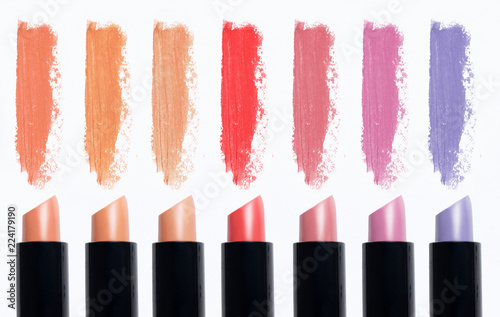 Cosmetics isolated on white background. Macro nude trend colors lipstick, strokes (smear)