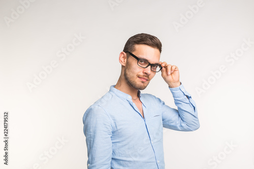 Young handsome man in glasses smiling isolated on white background