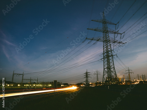 electricity pylons at sunset transporting clean renewable energy