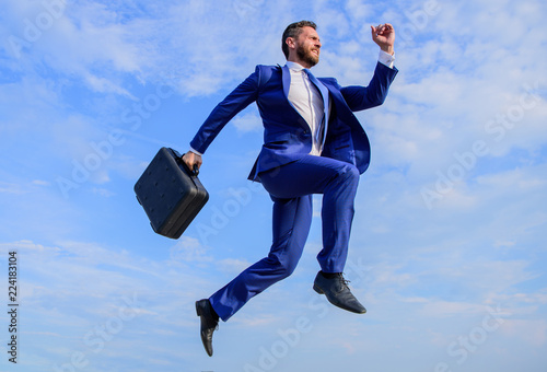 Success in business demands supernatural efforts. Businessman with briefcase jump high in motion forward. Supernatural power. Businessman formal suit make effort to succeed blue sky background