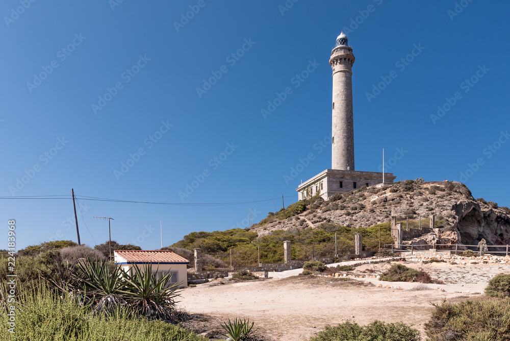 Lighthouse of Cabo de Palos, cape in the Spanish municipality of Cartagena, in the region of Murcia. It is summer, and the sky is a deep blue