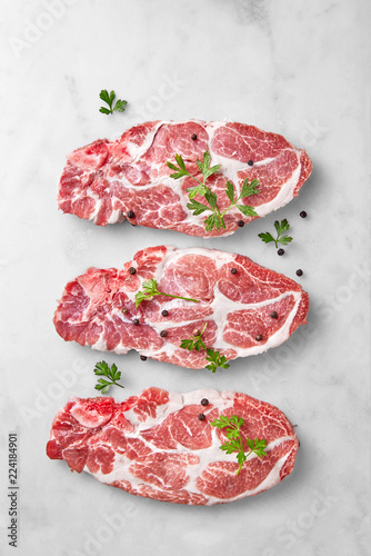 Fresh cut pork or beef meat isolated on a marble background viewed from above. Uncooked high protein red meat. Top view