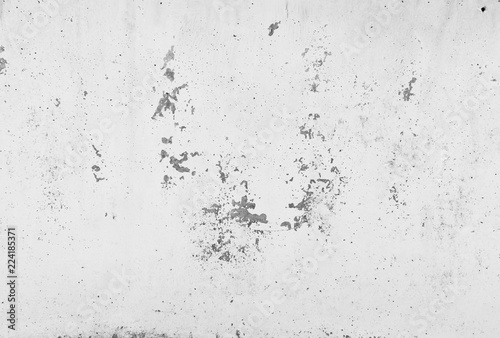 Peeling old white paint and plaster on cement wall background.